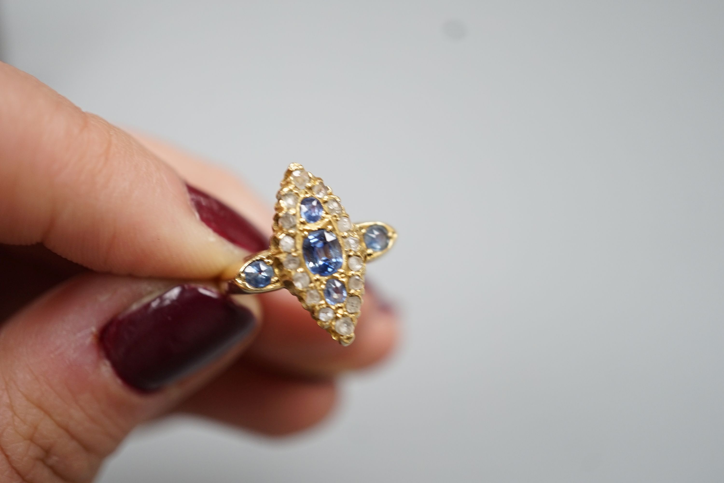 An Edwardian 18ct gold, sapphire and diamond set marquise set cluster ring, size K, gross weight 3.2 grams